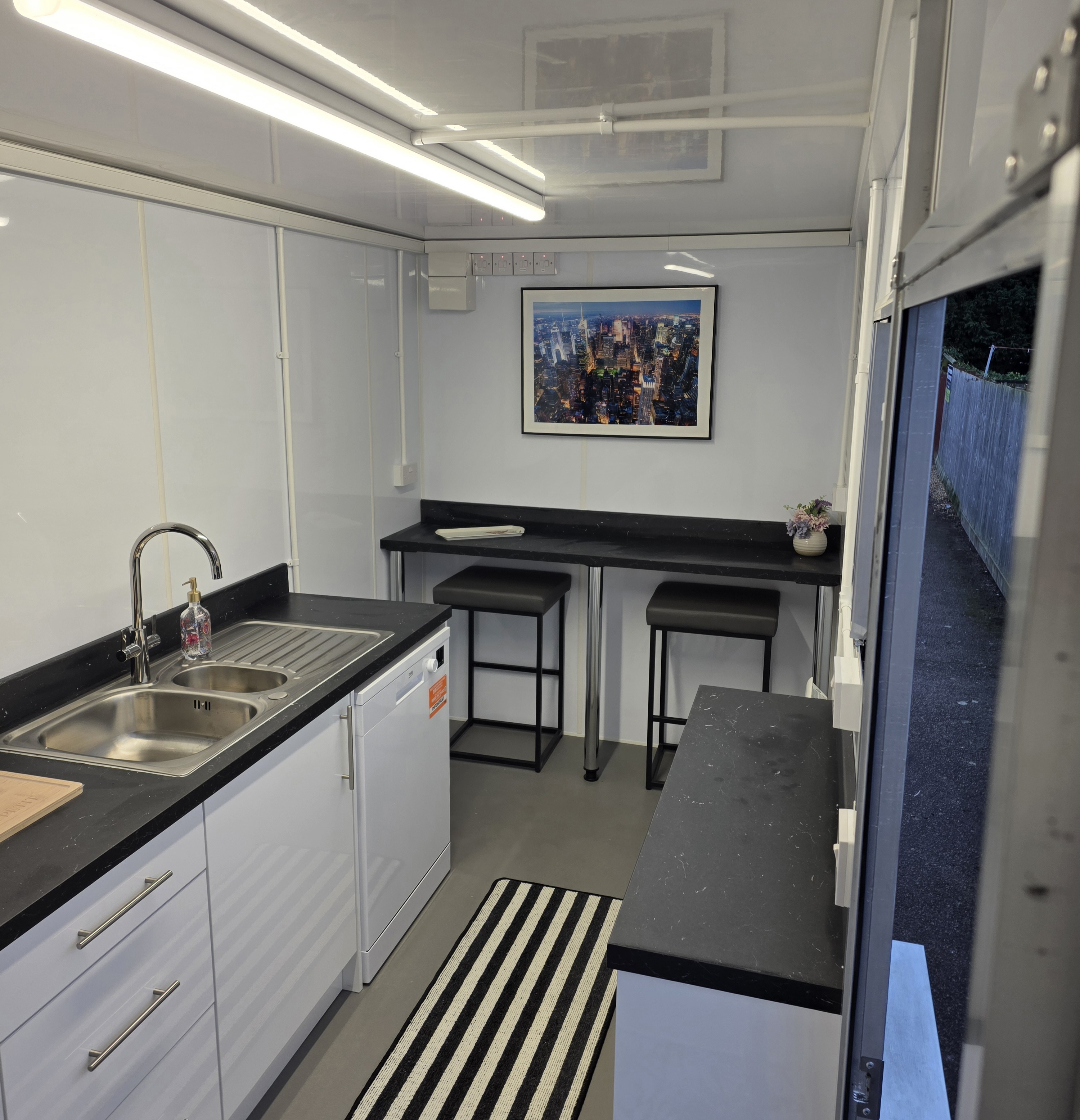 Kitchen pod — dining bar with city artwork